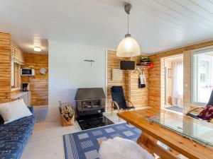 a living room with a couch and a fireplace at Holiday Home Jussinlahti by Interhome in Kortteinen