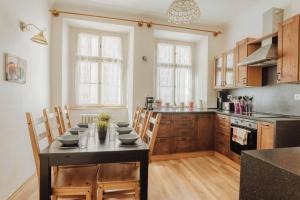 a kitchen with a table and chairs in a room at Central 3BD Apartment Old Town Square & Astronomical Clock 100 metres in Prague