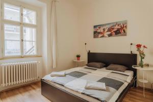 a bedroom with a large bed and a window at Central 3BD Apartment Old Town Square & Astronomical Clock 100 metres in Prague