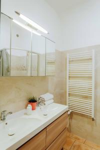 a bathroom with a sink and a mirror at Central 3BD Apartment Old Town Square & Astronomical Clock 100 metres in Prague