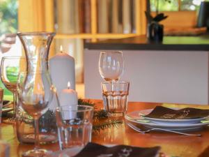 a table with wine glasses and candles on it at Chalet Edelweiss by Interhome in Saclentse