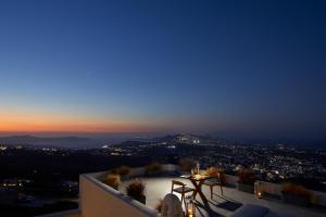 a view of a city at night at Arxegono Cave Houses Santorini in Pyrgos