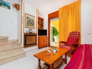 a living room with a couch and a table at Holiday Home Montalt IX by Interhome in Miami Platja