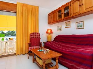 a living room with a bed and a table at Holiday Home Montalt IX by Interhome in Miami Platja