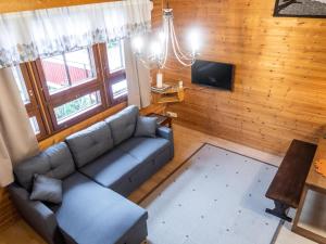 a living room with a couch and a tv at Holiday Home Konkelo 5 by Interhome in Kukkola