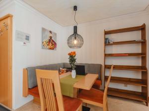 a living room with a table and a couch at Apartment Rose by Interhome in Bad Hofgastein