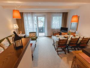 a living room with a table and a dining room at Apartment Sonnenappartements by Interhome in Bad Hofgastein