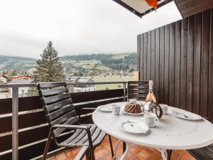 a white table and chairs on a balcony at Apartment Sonnenappartements by Interhome in Bad Hofgastein