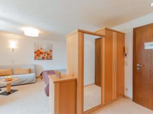a living room with a mirror and a couch at Apartment Rose by Interhome in Bad Hofgastein +34 photos