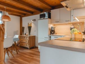 a kitchen with white cabinets and a counter top at Apartment Anna-Katharina by Interhome in Bad Hofgastein