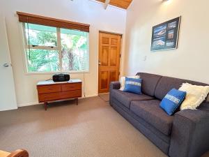 a living room with a couch and a window at Princes Retreat in Ngunguru