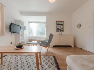 a living room with a table and a tv at Apartment Schubert-5 by Interhome in Bad Gastein