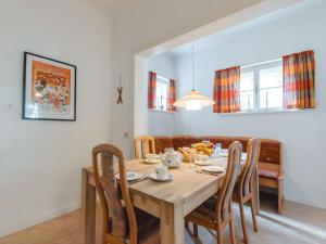 a dining room with a wooden table and chairs at Apartment Schubert by Interhome in Bad Gastein