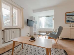 a living room with a table and a tv at Apartment Schubert by Interhome in Bad Gastein +32 photos