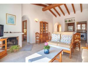 a living room with a couch and a fireplace at Apartment S'Atalaia Sea Views by Interhome in Port de Soller