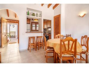 a kitchen and dining room with a table and chairs at Apartment S'Atalaia Sea Views by Interhome in Port de Soller +22 photos