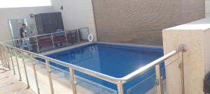 a swimming pool in a building with people standing around it at Antola Resort Al Rimal in Riyadh