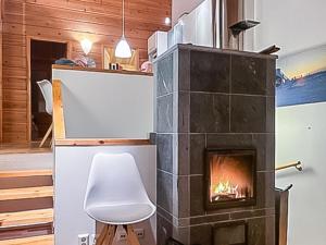a fireplace in the living room of a house at Holiday Home Sallan lumous a by Interhome in Salla
