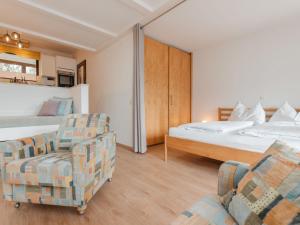 a hotel room with two beds and a couch at Apartment Hasennest by Interhome in Bad Hofgastein