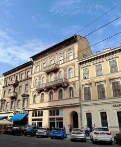 a large building with cars parked in front of it at NEW LISTING IN THE HEART OF BUDAPEST Apartment Kamilla in Budapest