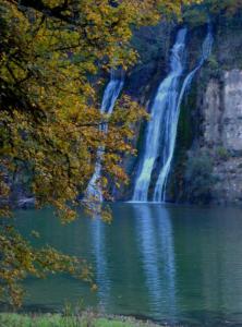 a waterfall in the middle of a body of water at Maison de vacances in Sapois