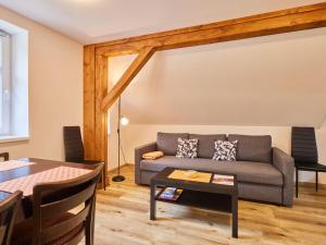 a living room with a couch and a table at Apartment Meda by Interhome in Bolkov