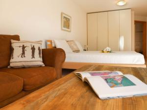 sala de estar con sofá y cama en Apartment Les Cîmes by Interhome, en Gryon