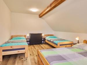 two twin beds in a room with wooden floors at Apartment Meda by Interhome in Bolkov