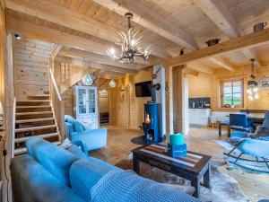 a living room with a blue couch and a table at Chalet Schwabenhütte by Interhome in Sirnitz-Sonnseite