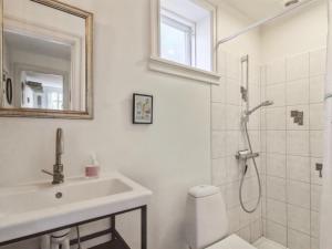 a white bathroom with a sink and a shower at Apartment Marisol - 700m from the sea in NW Jutland by Interhome in Skagen