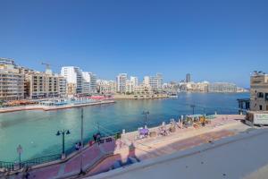 a view of a river in a city with buildings at Seafront Traditional Maltese Townhouse Balluta Bay in Sliema