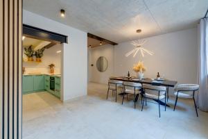 a kitchen and dining room with a table and chairs at Seafront Traditional Maltese Townhouse Balluta Bay in Sliema