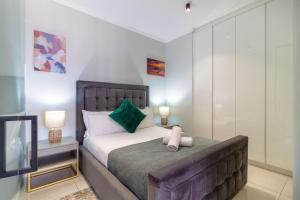 a bedroom with a large bed and a television at AlimamaSpaces The Moksit Suite Ellipse in Midrand