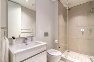 a bathroom with a sink and a toilet and a shower at AlimamaSpaces The Moksit Suite Ellipse in Midrand +20 photos