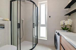 a bathroom with a shower and a toilet and a sink at Apartments Olive Gardens 2 in Novalja +57 photos