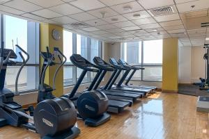 a gym with rows of tread machines in a room at Frank Porter - Bay Central in Dubai