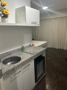 a bathroom with a sink and a counter top at Suites Pampulha Hotel in Belo Horizonte