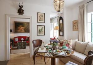 a living room with a table and a couch at Garden Cottage der Villa Liechtenstein in Altaussee