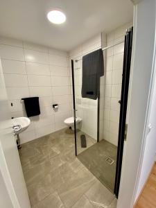 a bathroom with a shower and a toilet at To Be in Sankt Andrä