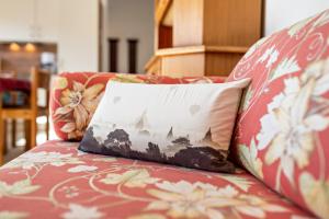 a red couch with a pillow on it at Ferienwohnung Rennbachtal in Bad Herrenalb