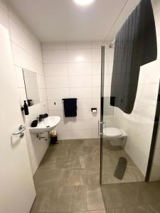 a bathroom with a shower and a sink and a toilet at To Be in Sankt Andrä