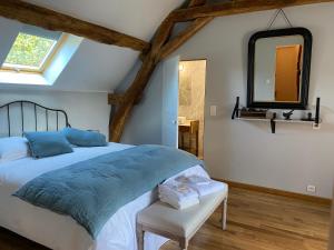 a bedroom with a large bed and a mirror at Maison de Campagne avec Piscine, Vallée de la Loire in Sarcé +23 photos