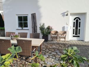 a patio with a wooden table and chairs at Ferienhaus Alpenblick in Bad Wurzach