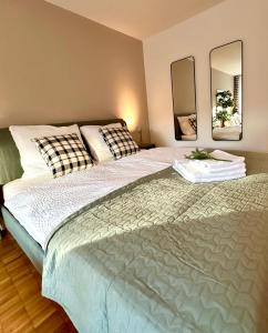a bedroom with a large bed with two mirrors at New Studio with Sunny Terrace & Air Condition in Zürich