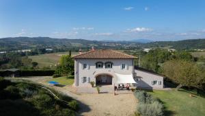 ein großes weißes Haus mit einem Zelt davor in der Unterkunft VILLA IL MAGNIFICO 10, Emma Villas in Reggello