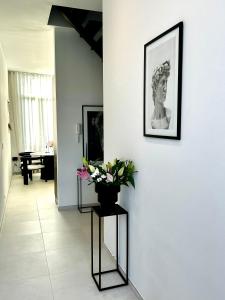 een hal met een vaas met bloemen aan de muur bij Phoenix garden in Bergen