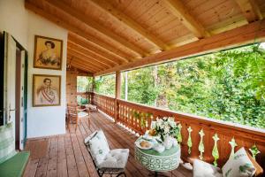 a wooden deck with a table and chairs on it at Garden Cottage der Villa Liechtenstein in Altaussee