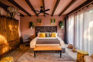 a bedroom with a large bed with yellow pillows at Casamada Residences in Guanajuato