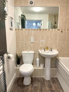 a bathroom with a white toilet and a sink at Stockwood Apartment by Cliftonvalley Apartments in Bristol