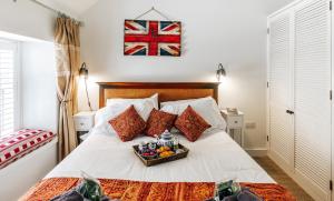 een slaapkamer met een bed en een dienblad met fruit erop bij Delightful Cotswold Cottage for two, Log Burner, Garden & Dog Friendly in Northleach